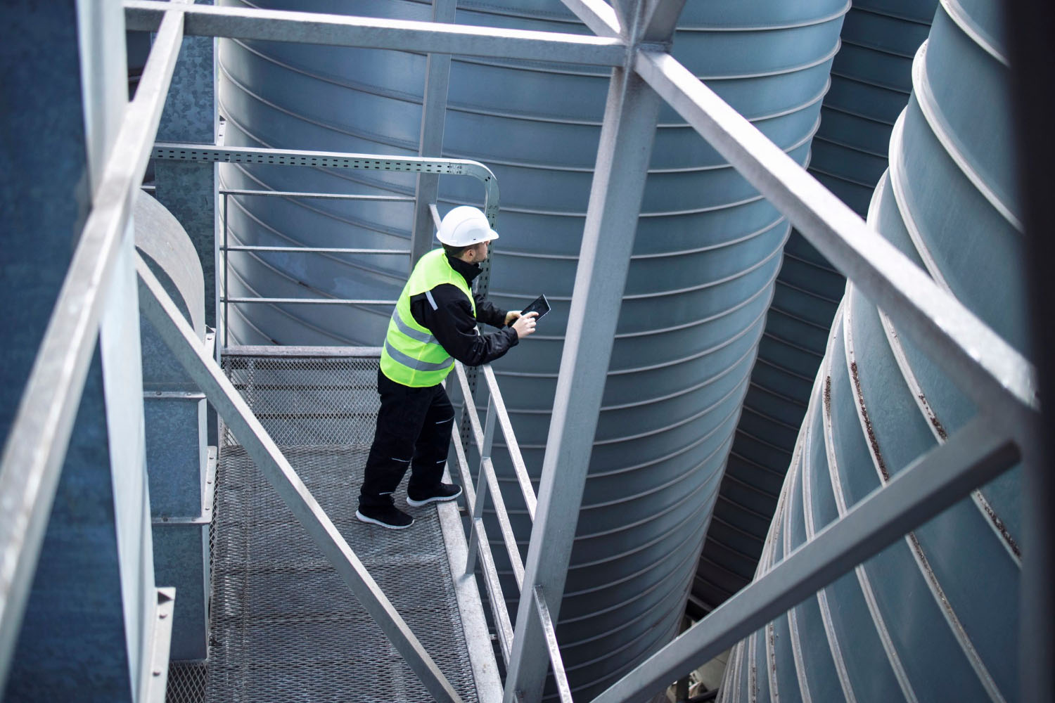 factory-silos-worker-standing-metal-platform-industrial-storage-tanks-looking-tablet-about-food-production.jpg